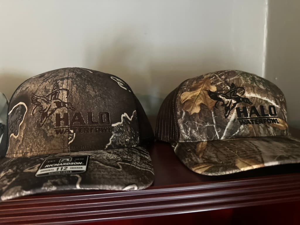 Two camo trucker hats