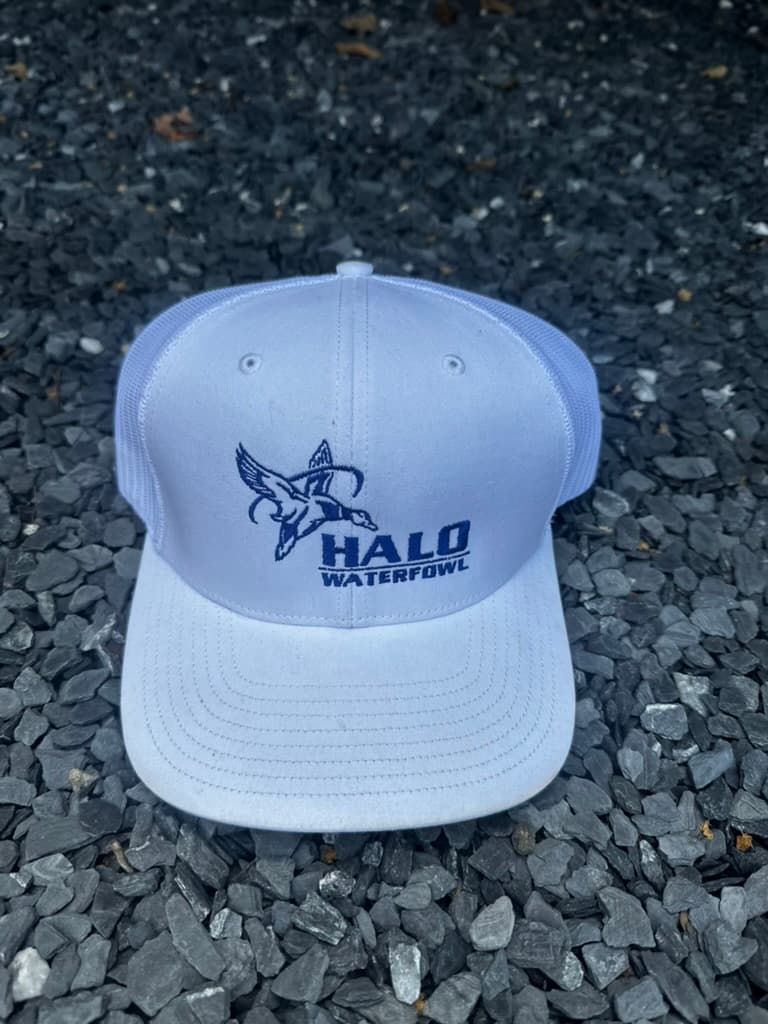 White trucker hat with navy logo